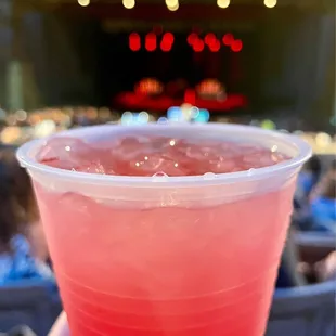 a red drink in a plastic cup