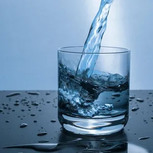 a glass of water being poured