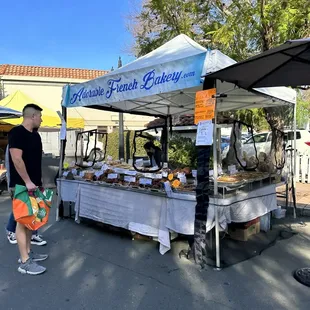 man standing in front of a food stand