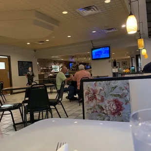 people sitting at tables in a restaurant