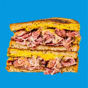 Pastrami Sandwich - RC Provisions pastrami, pickle, Zab&apos;s Hot Honey Mustard, on toasted rye bread.