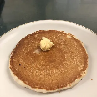 a stack of pancakes with butter on top