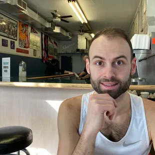 Cute man eating inside