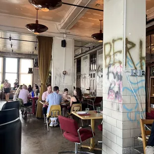 people sitting at tables in a restaurant