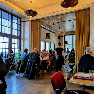 people sitting at tables in a restaurant