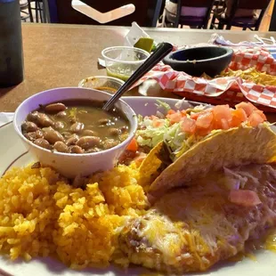 Combo #4 enchilada, chili, Riano taco and beans and rice.