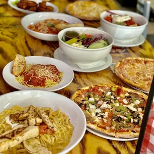 a variety of pizzas on a table