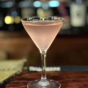 a pink cocktail in a coupe glass