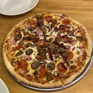 a pizza with pepperoni and sausage