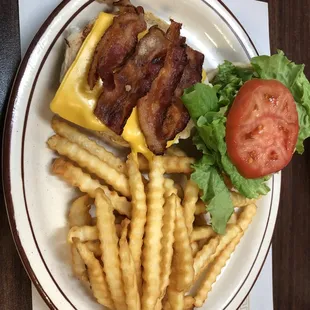 a plate of food with bacon, cheese, lettuce, tomato, and french fries