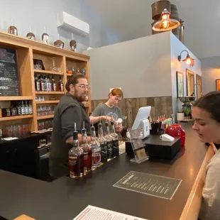 a man and a woman behind a bar