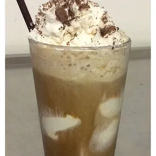 a milkshake with whipped cream and chocolate sprinkles