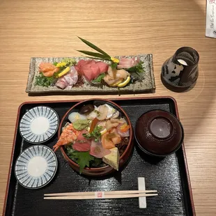 a plate of sushi and chopsticks