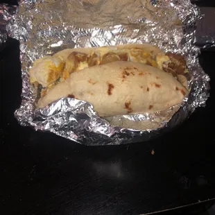 a burrito wrapped in aluminum foil
