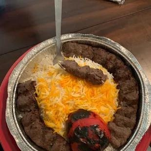 Kabobs and rice with grilled tomato