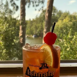 a drink with a cherry on the rim
