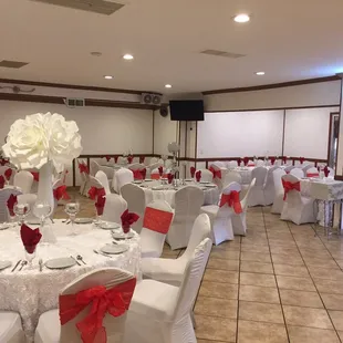 a banquet hall decorated with white and red decorations