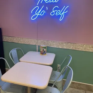 a neon sign that reads treat go self