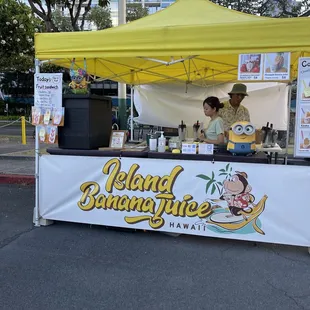 a woman standing under a yellow canopy
