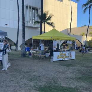 a group of people standing under a tent