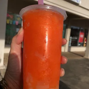 a hand holding a cup of bubble tea