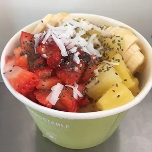 Açaí sorbet topped with bananas, strawberries, pineapple, chai seeds, honey and coconut flakes.