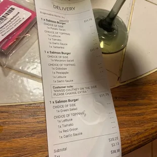 a receipt and a bottle of beer