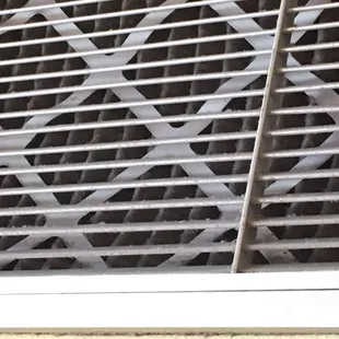 Filthy air-conditioning vent on the wall directly next to my table, less than 3 feet.