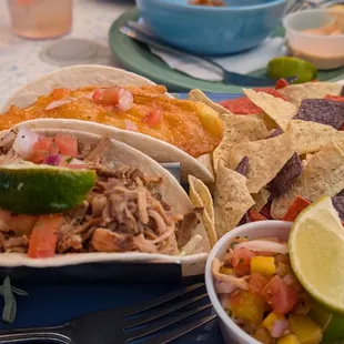 1 halibut and 1 pulled pork taco.  (You have to ask) They have corn tortillas too