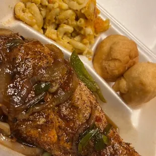 a plate of food with a side of macaroni and cheese