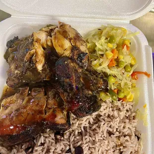 Jerk chicken with rice and peas and steam cabbage