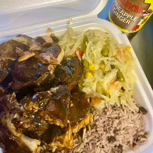 Jerk pork with rice and peas and steam cabbage