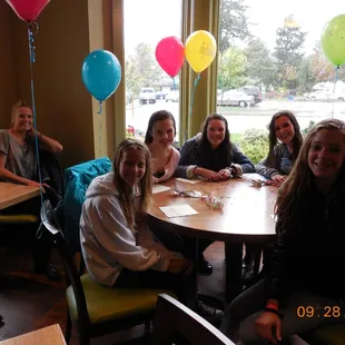 a group of people sitting around a table