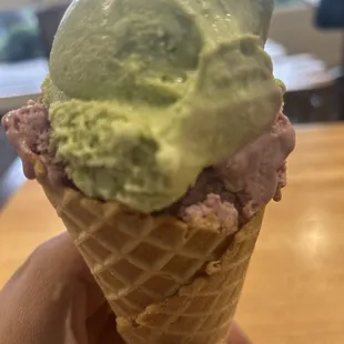 Green tea and blackberry icecream on a waffle cone