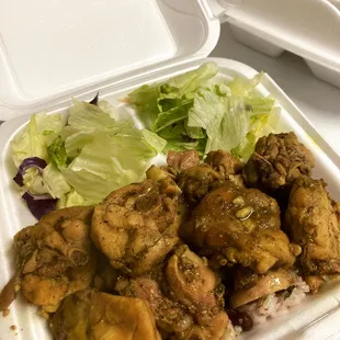 chicken, lettuce, and salad in a styrofoam container