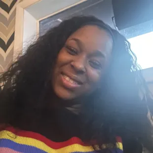 a woman smiling and looking at the camera