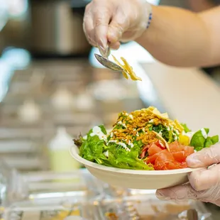 a person serving a salad