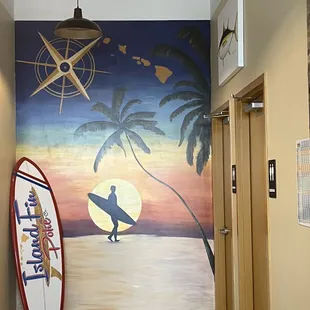 a surfer and a surfboard in a hallway