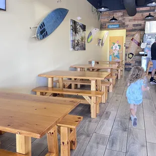 a little girl running through a restaurant