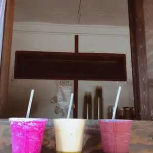 three cups of drink on a table