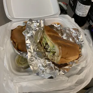 a sandwich wrapped in aluminum foil