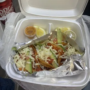 a container of food and a can of soda