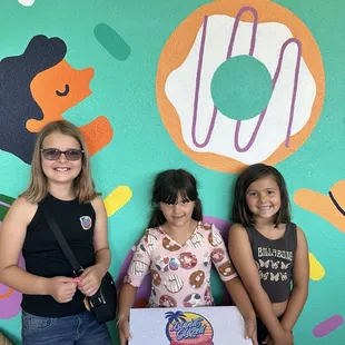 Sisters excited for donuts! One of them is wearing a donut dress!!!!