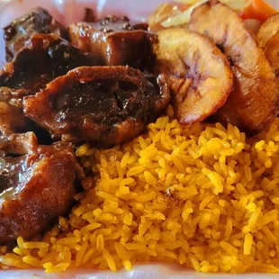 Oxtails over Yellow Rice with Plantains and Cabbage/Pepper medley.