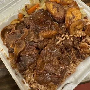 Oxtails, rice and peas,and cabbage