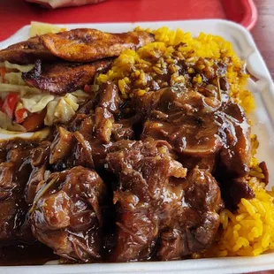 Oxtails with yellow rice, cabbage, and plantains. Good.