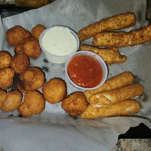 a basket of fried breadsticks and dipping sauce
