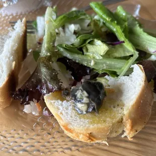 Garlicky Escargot on soft bread with parmasean topped crust