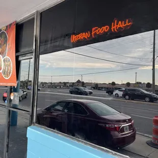 a reflection of a car in the window