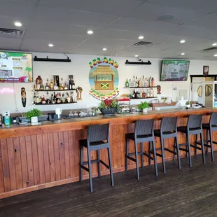 a bar with chairs at the counter